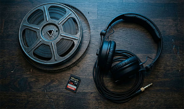 Browser window showing a royalty-free stock media platform with music tracks, video clips and image thumbnails